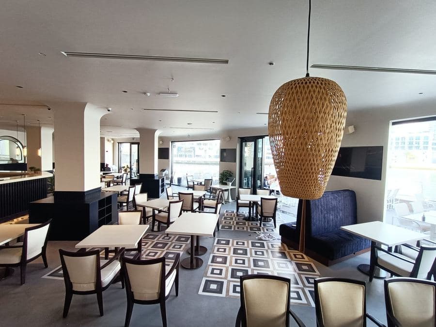 Café bar with brass pendant lights and patterned floor
