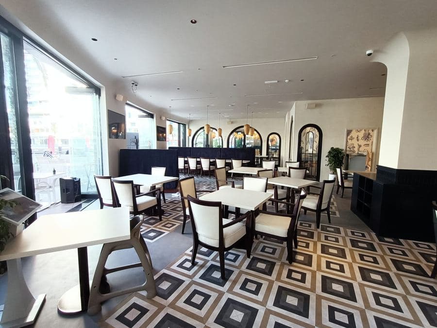 Café seating with arched mirrors and greenery