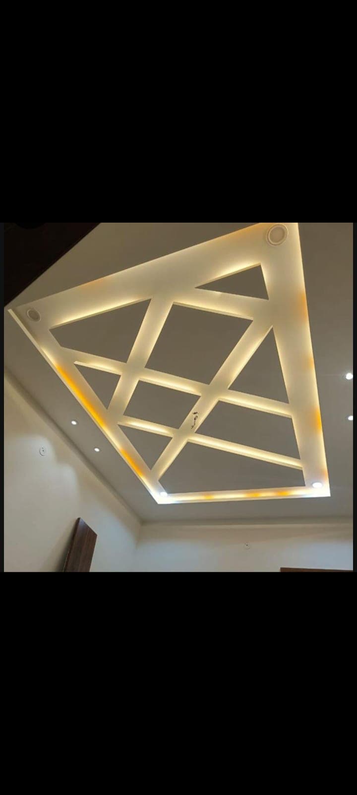 Diamond-cut gypsum ceiling with warm cove lighting