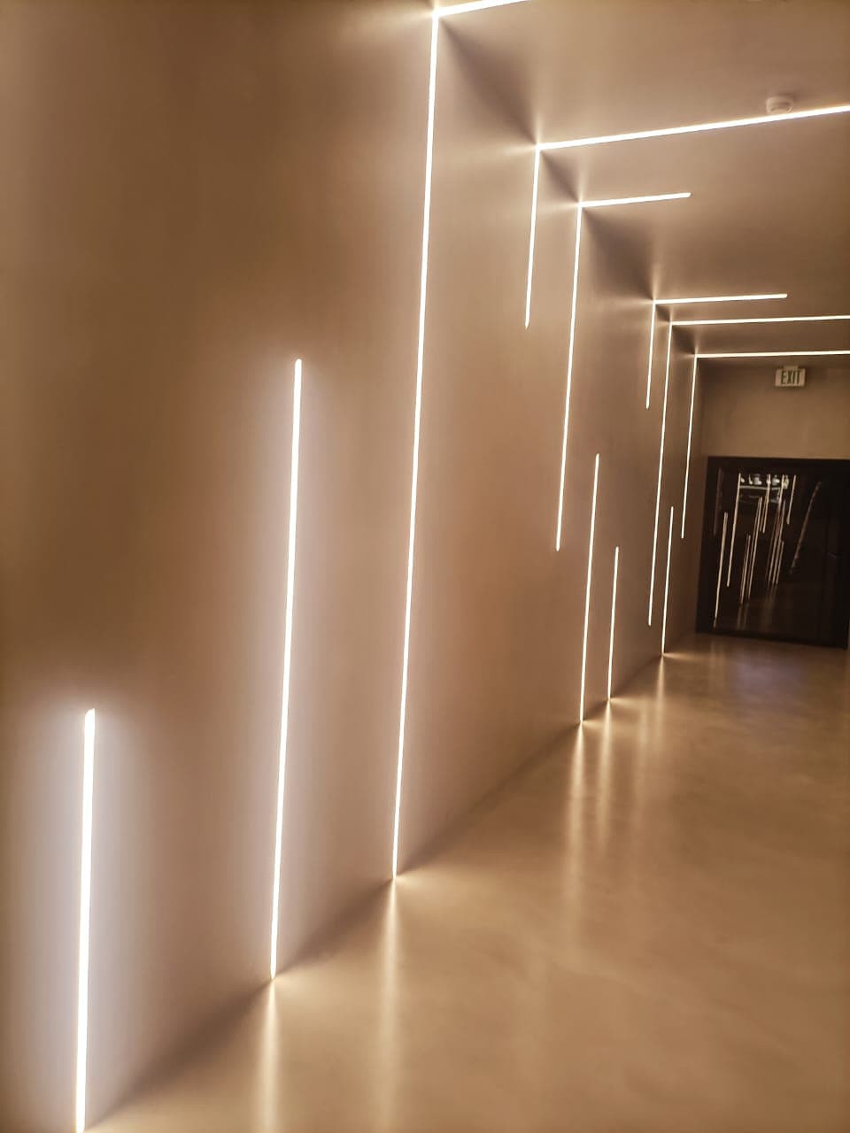 Minimalist corridor with vertical and horizontal linear LED lighting