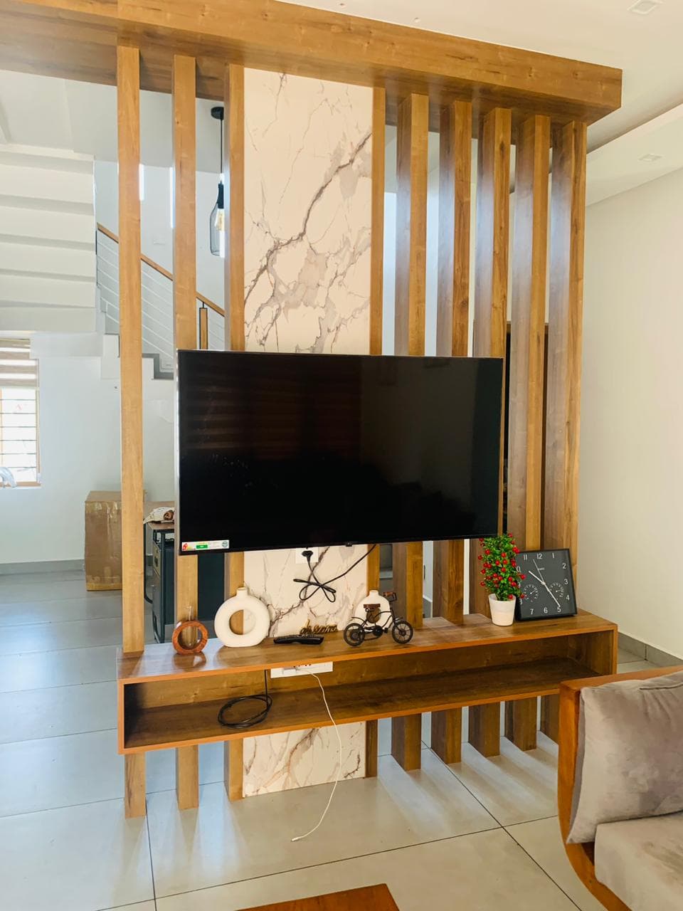 Slatted wood television feature wall with marble inlay
