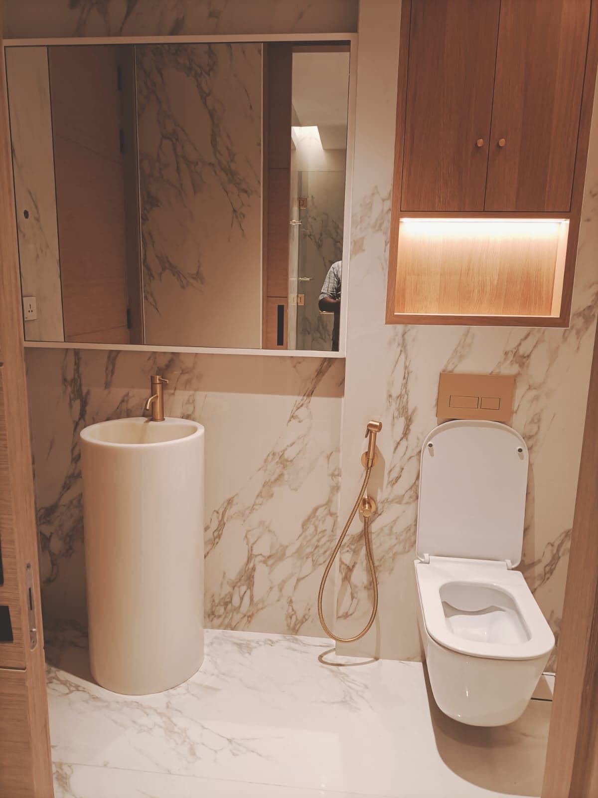 Black marble bathroom with brass fittings and soaking tub