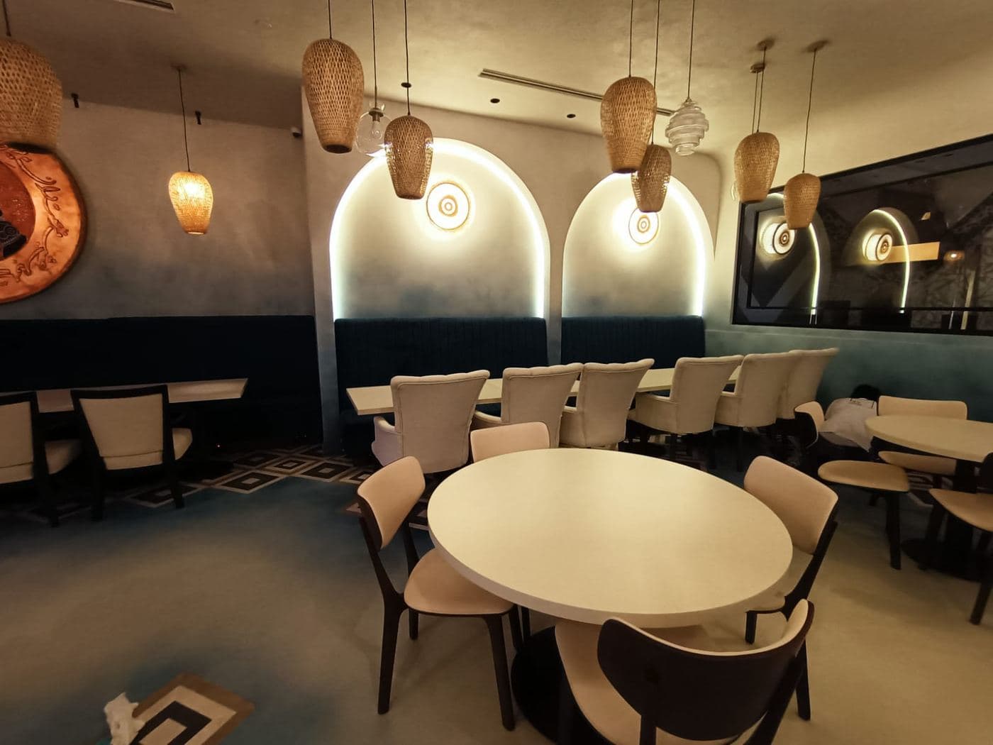 Commercial café interior with arched niches and rattan lighting
