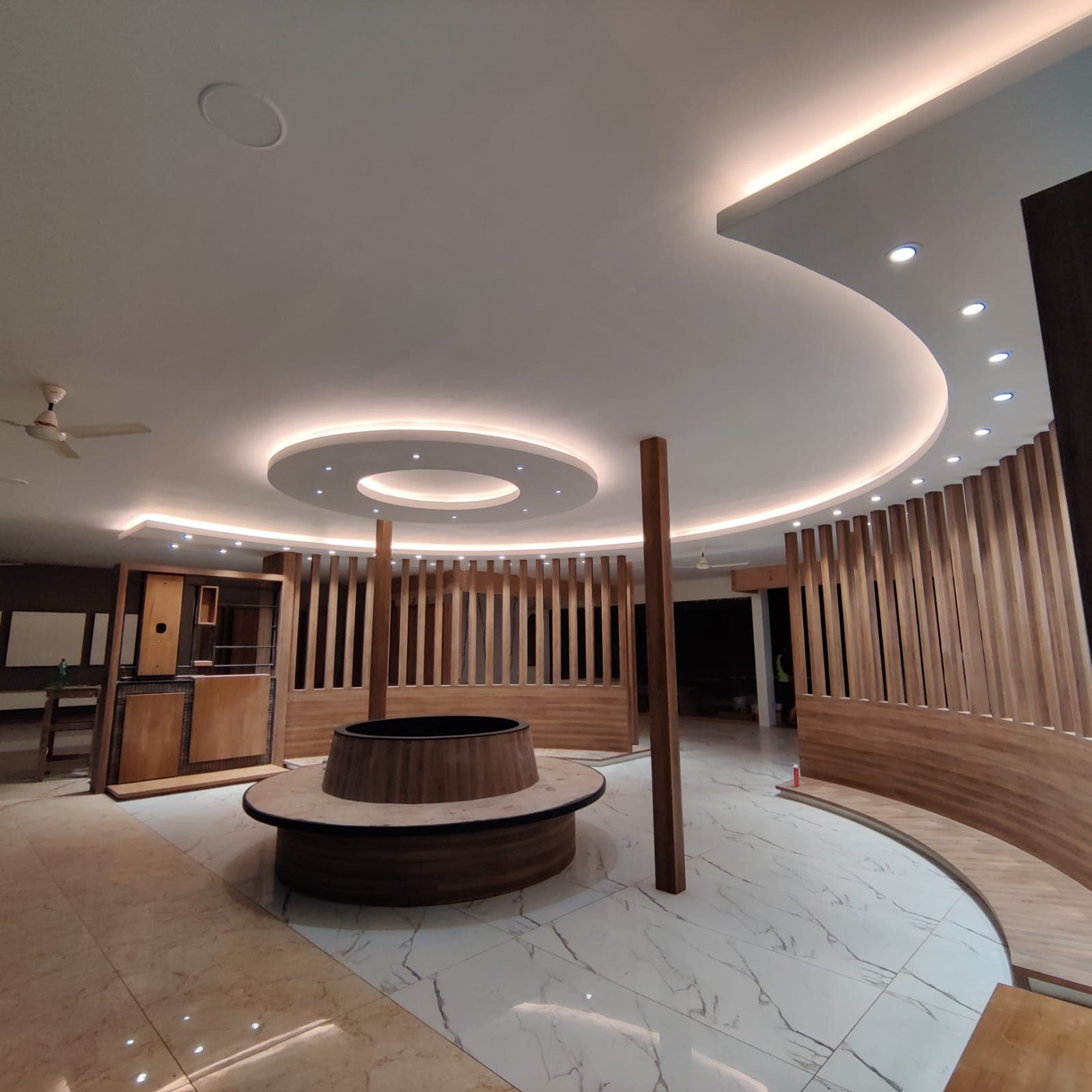 Concentric cove-lit ring ceiling over a circular reception desk